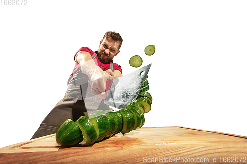 Image of Amazing caucasian man preparing unbelievable food with action, details and bright emotions, professional cook isolated on white studio background.