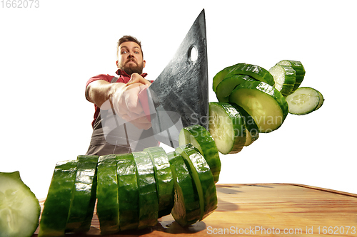 Image of Amazing caucasian man preparing unbelievable food with action, details and bright emotions, professional cook isolated on white studio background.