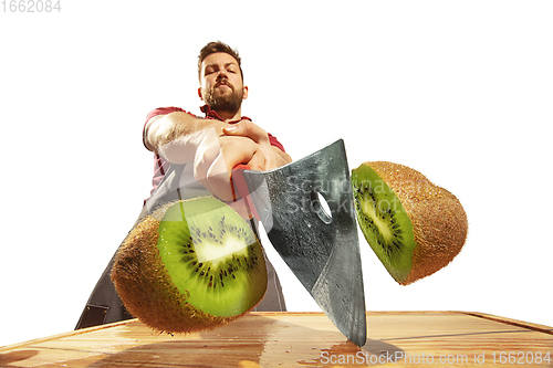 Image of Amazing caucasian man preparing unbelievable food with action, details and bright emotions, professional cook isolated on white studio background.