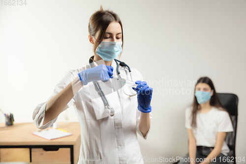 Image of Doctor or nurse giving vaccine to patient using the syringe injected in hospital