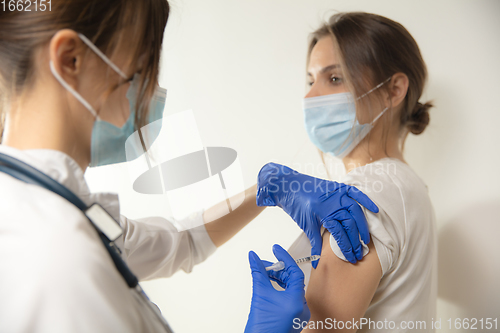 Image of Close up doctor or nurse giving vaccine to patient using the syringe injected in hospital