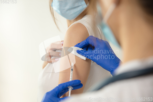 Image of Close up doctor or nurse giving vaccine to patient using the syringe injected in hospital