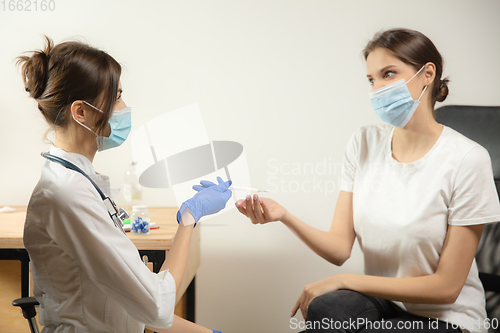 Image of Doctor or nurse giving vaccine to patient using the syringe injected in hospital