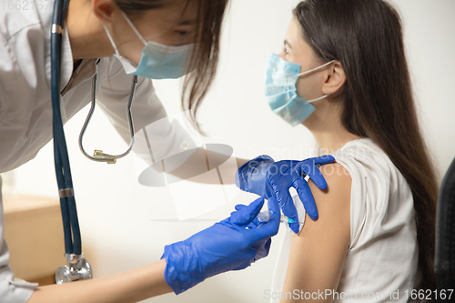 Image of Close up doctor or nurse giving vaccine to patient using the syringe injected in hospital