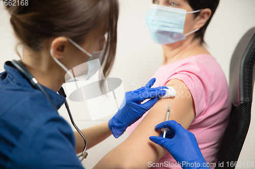 Image of Close up doctor or nurse giving vaccine to patient using the syringe injected in hospital