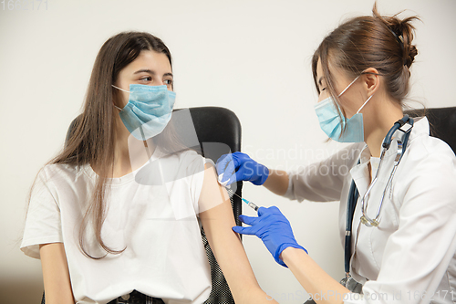 Image of Close up doctor or nurse giving vaccine to patient using the syringe injected in hospital