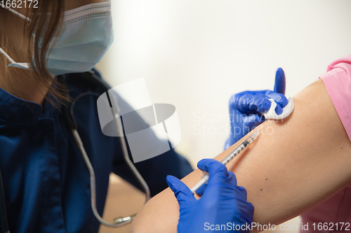 Image of Close up doctor or nurse giving vaccine to patient using the syringe injected in hospital