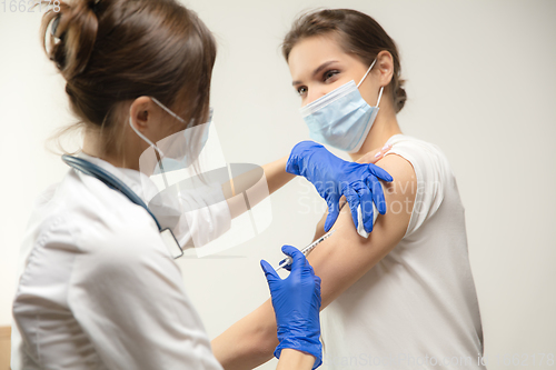 Image of Close up doctor or nurse giving vaccine to patient using the syringe injected in hospital