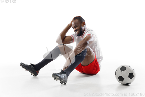 Image of Funny emotions of professional football, soccer player isolated on white studio background, excitement in game