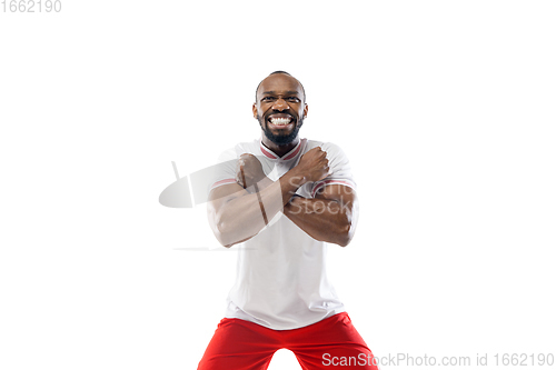 Image of Funny emotions of professional football, soccer player isolated on white studio background, excitement in game