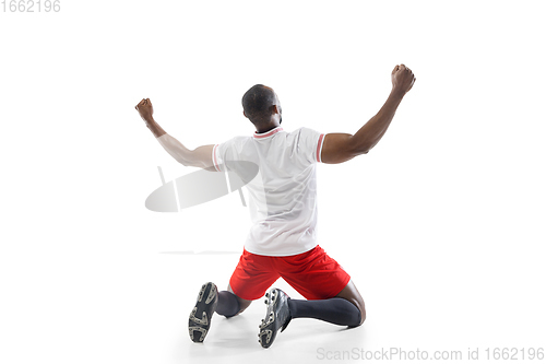 Image of Funny emotions of professional football, soccer player isolated on white studio background, excitement in game