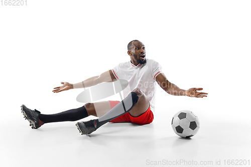 Image of Funny emotions of professional football, soccer player isolated on white studio background, excitement in game