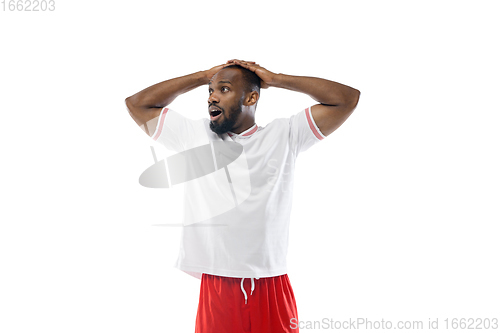 Image of Funny emotions of professional football, soccer player isolated on white studio background, excitement in game