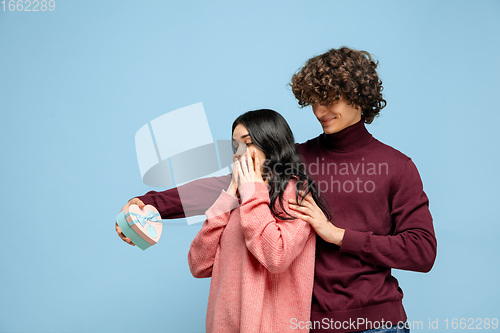 Image of Beautiful couple in love on blue studio background. Valentine\'s Day, love and emotions concept