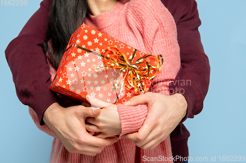 Image of Close up beautiful couple in love on blue studio background. Valentine\'s Day, love and emotions concept