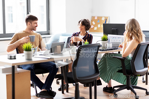 Image of team of startuppers drinking coffee at office