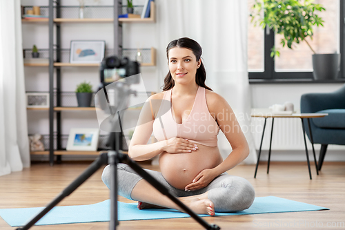 Image of happy pregnant woman blogger recording yoga video