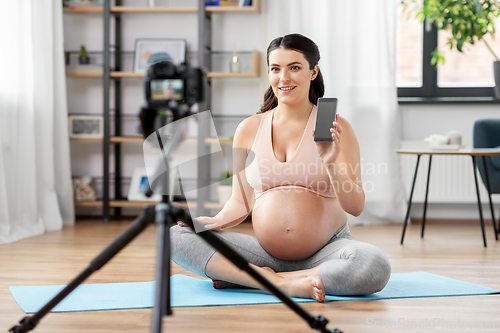 Image of happy pregnant woman blogger recording yoga video