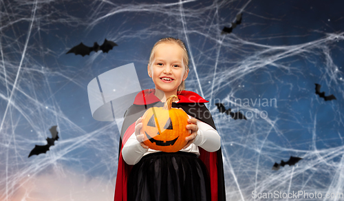 Image of girl in halloween costume of dracula with pumpkin