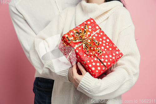 Image of Close up beautiful couple in love on pink studio background. Valentine\'s Day, love and emotions concept