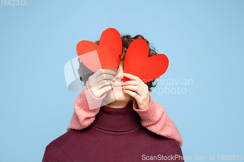 Image of Beautiful couple in love on blue studio background. Valentine\'s Day, love and emotions concept