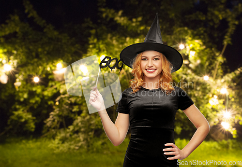 Image of woman in halloween costume of witch with accessory