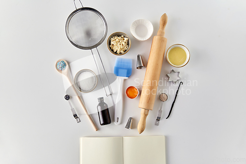 Image of recipe book and cooking ingredients on table