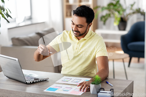 Image of ui designer working on user interface at home