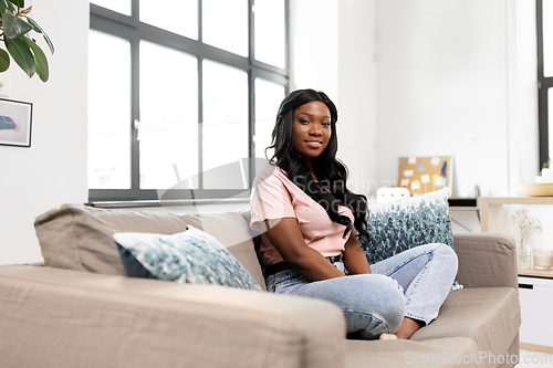 Image of happy african american young woman at home