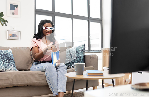 Image of happy african american woman watching tv at home