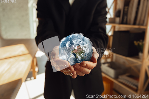 Image of Hands holding planet Earth, close up. Environment save, taking care of nature and ecology, supporting hands concept