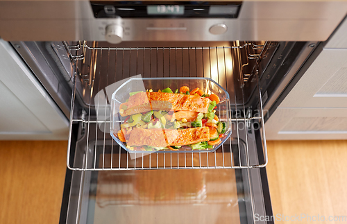 Image of food cooking in baking dish in oven at home