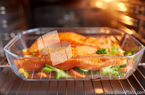Image of food cooking in baking dish in oven at home