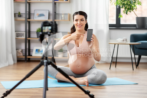 Image of happy pregnant woman blogger recording yoga video