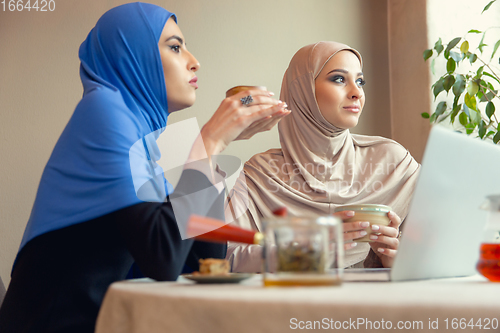 Image of Beautiful arab women meeting at cafe or restaurant, friends or business meeting