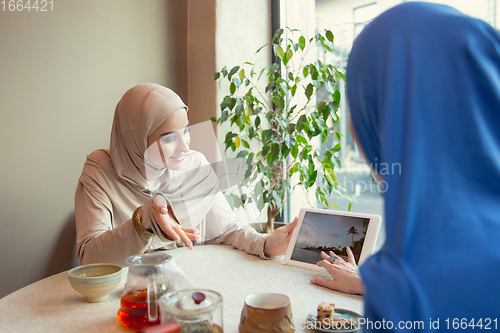 Image of Beautiful arab women meeting at cafe or restaurant, friends or business meeting