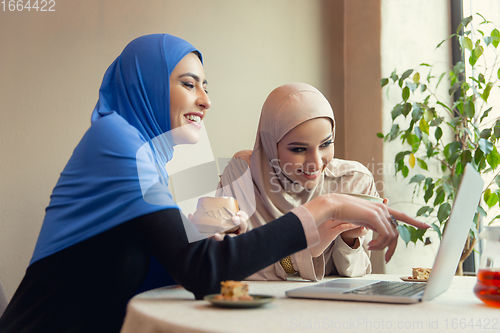 Image of Beautiful arab women meeting at cafe or restaurant, friends or business meeting