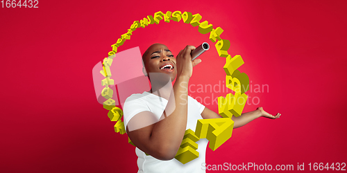Image of Woman shouting, singing with speaker, microphone on studio background. Sales, offer, business, cheering fun concept.