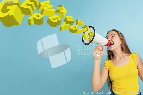 Image of Girl shouting with megaphone, loudspeaker on studio background. Sales, offer, business, cheering fun concept.