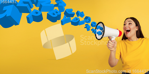 Image of Woman shouting with megaphone, loudspeaker on studio background. Sales, offer, business, cheering fun concept.