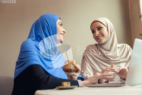 Image of Beautiful arab women meeting at cafe or restaurant, friends or business meeting