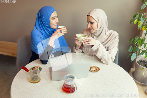 Image of Beautiful arab women meeting at cafe or restaurant, friends or business meeting