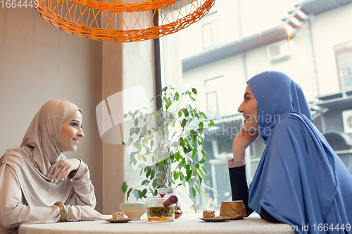 Image of Beautiful arab women meeting at cafe or restaurant, friends or business meeting