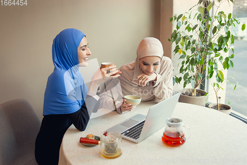 Image of Beautiful arab women meeting at cafe or restaurant, friends or business meeting