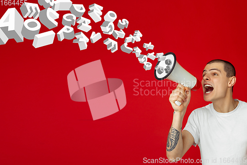 Image of Man shouting with megaphone, loudspeaker on studio background. Sales, offer, business, cheering fun concept.