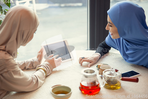 Image of Beautiful arab women meeting at cafe or restaurant, friends or business meeting