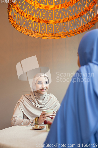 Image of Beautiful arab women meeting at cafe or restaurant, friends or business meeting