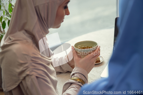 Image of Beautiful arab women meeting at cafe or restaurant, friends or business meeting