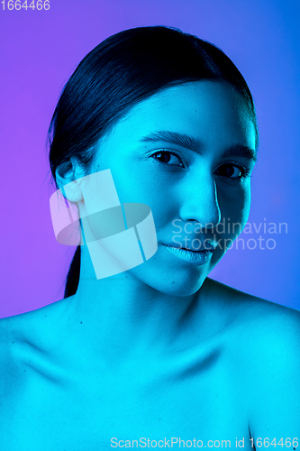 Image of Beautiful east woman portrait isolated on gradient studio background in neon light, monochrome