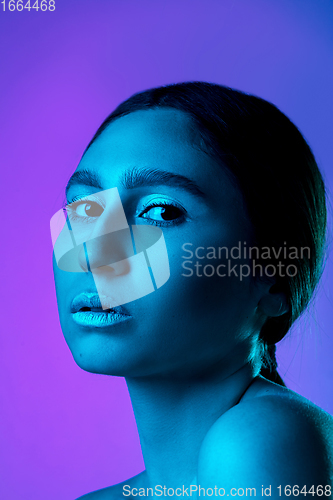 Image of Beautiful east woman portrait isolated on gradient studio background in neon light, monochrome